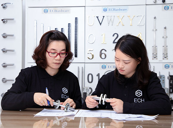 two employees checking door hardware design for odm molding